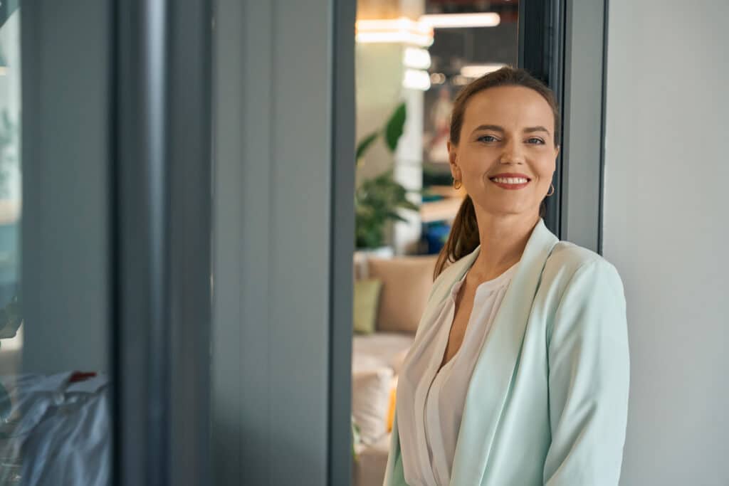 Smiling successful lady enjoying break at work